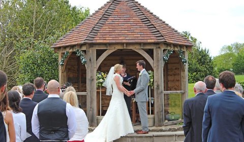 Bride and groom getting married at outdoor Shropshire wedding venue 
